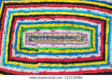 Colorful hand made knitted rug. Reuse of supermarket plastic bag, package. Folk nation creativity. Rustic style. Rough texture  and bright design