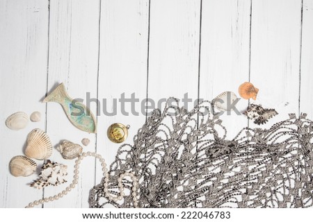 Sea theme border background with network, seashell, fish and pearl chaplet on a white vintage wooden boards. Vintage shabby chic style for card design