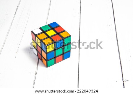 KIROV, RUSSIA - OCTOBER 06, 2014: Rubik\'s cube on the white wooden background. Rubik\'s Cube invented by a Hungarian architect Erno Rubik in 1974.