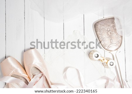 Vintage classic composition with antique mirror, binoculars, pointes on a white wooden background shabby chic style dance theme