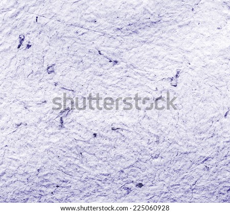 Homemade hand crafted textured paper with inclusions of gold foil and floral petals on a violet lavender background. Useful for scrapbooking and greeting cards