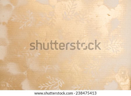 Golden pattern with branches and leaf silhouettes golden spray color on a corrugated paper carton