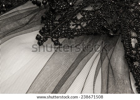 Ballet shopenka skirt with beads embroidery on lace on a dark wooden background