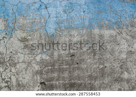 Grunge Background. Wall with the blue colored whitewash falling off fragment with clacks as a background texture