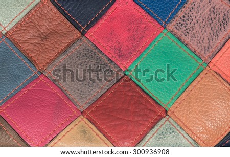 Stylish bright leather bag of square colorful patches. Close-up photo