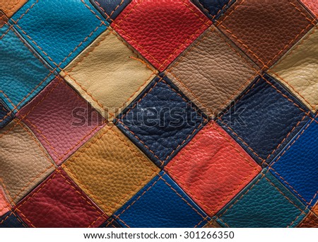 Stylish bright leather bag of square colorful patches. Close-up photo