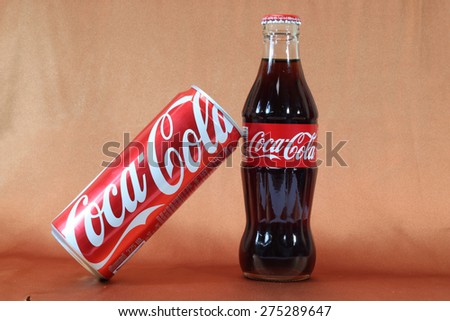 CHIANGMAI, THAILAND- May 5, 2015Coke , Coca Cola cans and bottles on a brown cloth background.