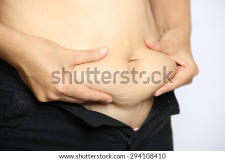 fat woman measuring her stomach