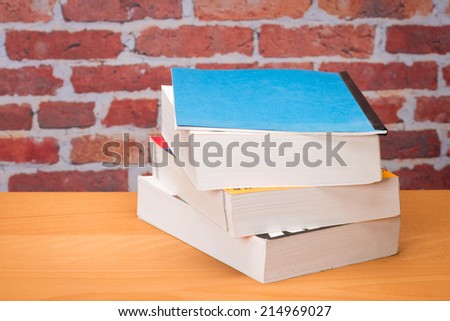 Book for school in front of brick wall