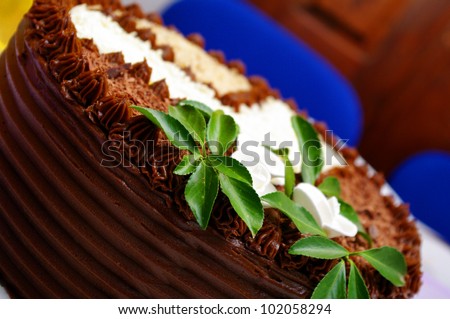 Chocolate cake with nuts, almond and laurel. Decorated with laurel leaf.