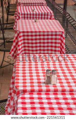 Red and White Table Cloths on Square Tables Outdoors