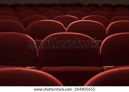 Close up with red seats in theater hall