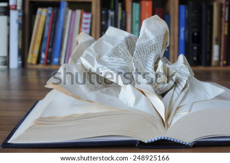 Dyslexia. An opened book with crumpled pages, to indicate the difficulty to read.