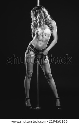 Young sexy pole dance woman. Contrast black and white colors.