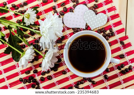 romantic mug of coffee and flower on striped napkin