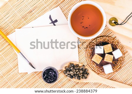 write letter and chinese tea on wooden table, top view