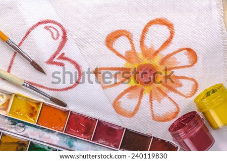 artist\'s brush on a background painted flower and heart