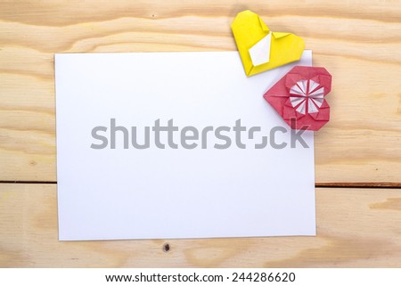 two origami hearts and white paper sheet for love letter.