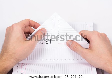male hands folded sheet of paper from the diary