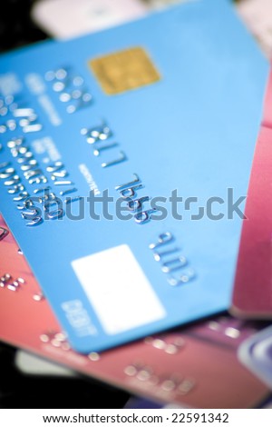 A pile of credit cards with all personal information and logos altered or removed.