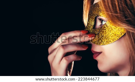 Blond Woman with Mask of Feathers in Low Key