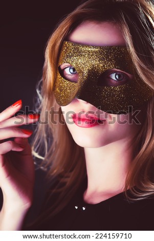 Blond Woman with Mask of Feathers in Low Key