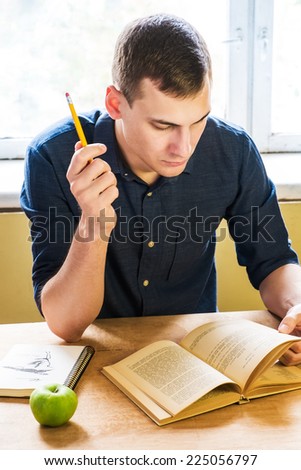 handsome young man studying hard