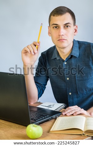 handsome handsome young man preparing lessons. attractive male working and studying on computer