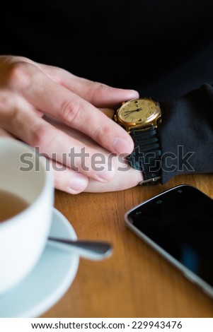 Man sitting in a cafe watching the watches