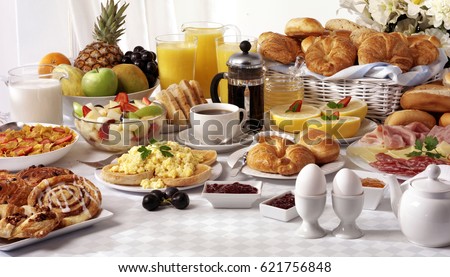BREAKFAST TABLE FILLED WITH ASSORTED FOODS,SAVOURY,SWEET,PASTRIES,HOT AND COLD DRINKS