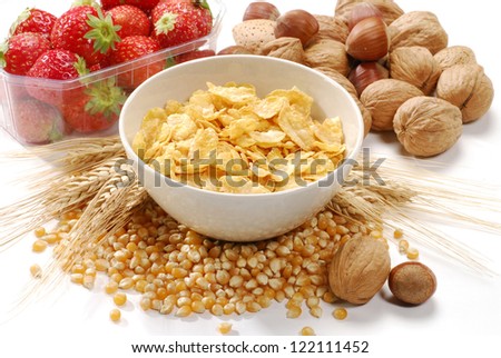 Corn flakes cereal bowl and fruit ingredients.