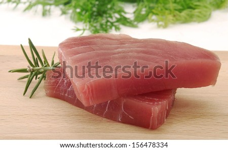 Tuna steaks and rosemary ingredient.Tuna fish slices.