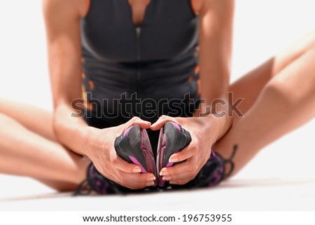 Stretching sporting runner woman.Fit woman stretching her leg to warm up - isolated over white background