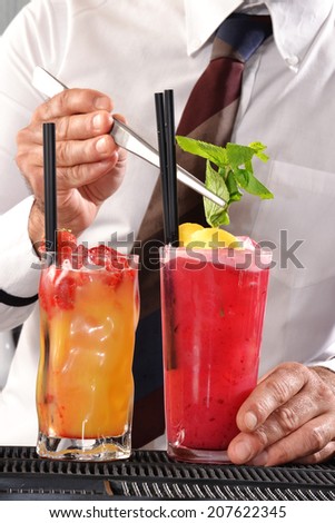 Bartender preparing cocktail drinks,barman preparing cocktail.