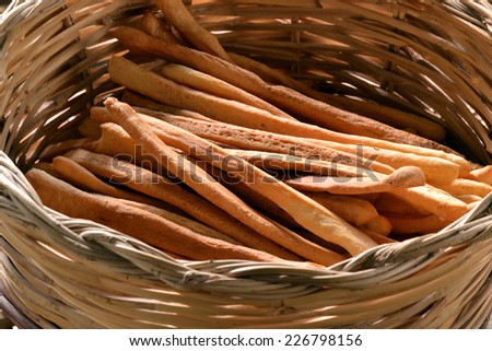 Grissini. fresh bread sticks in a basket on wooden table