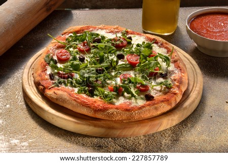 Home made pizza on rustic background.