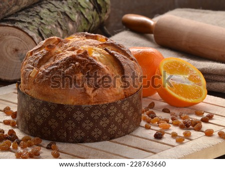 Panettone bread and ingredients on rustic wood ambient.Panetone and ingredients.Traditional christmas food.