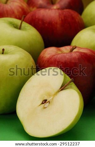 Still life with several types of apples and half apple.