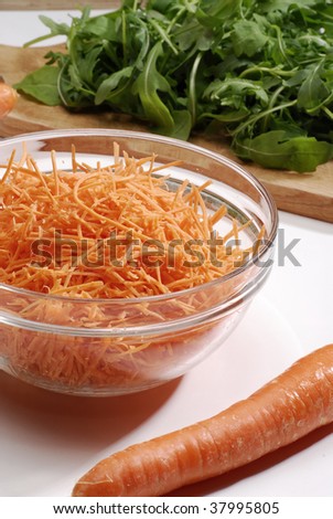 Fresh carrot in glass bowl and carrots. Fresh carrot in glass bowl and rocket.