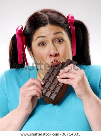 stock photo One happy fat girl eating a chocolate bar