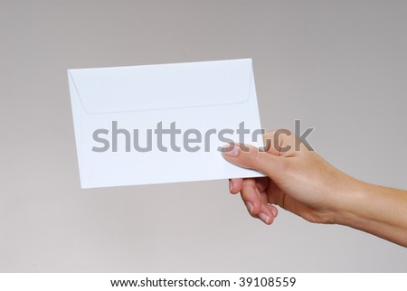 Young woman hand holding an envelope isolated on a white background.