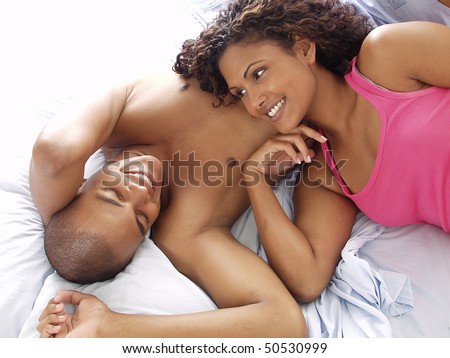Afro american couple on bed.