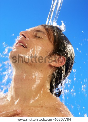 stock photo Young latin man taking a shower