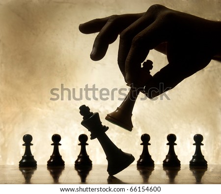 Playing chess game. defeating the Queen.