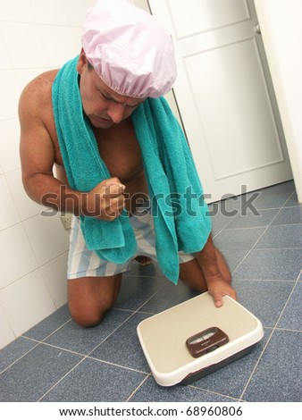 Man using a weight scale in a bathroom.