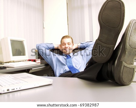 Relaxed businessman working in office.