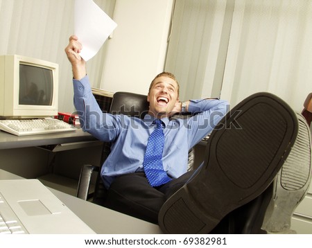 Relaxed businessman working in office.