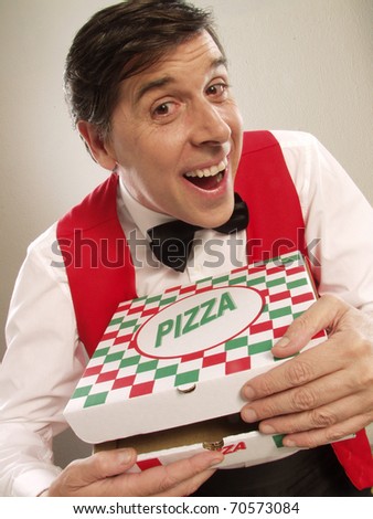 Pizza delivery man holding pizza box . Waiter holding a pizza box.