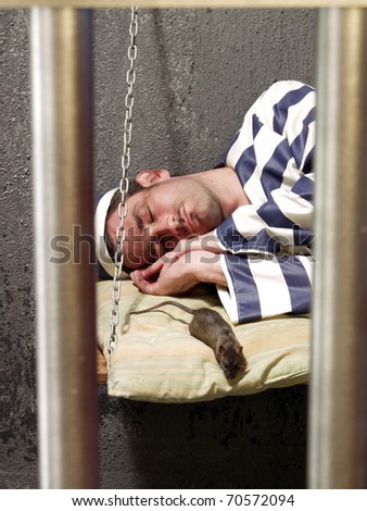 Depressed prisoner in a prison cell.