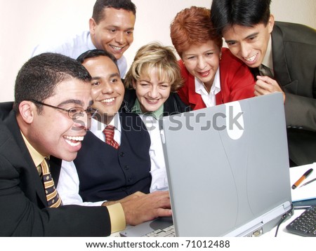 Business team watching a computer in an office.